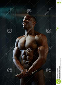 body builder naked portrait smiling african american male bodybuilder naked torso posing black studio background human body perfection stock photo