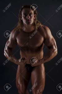 sexy bodybuilder man stryjekk athletic sexy male body builder blonde long hair black background stock photo